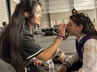 applying make up at Festival of the Arts