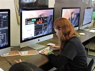 student sitting at a computer