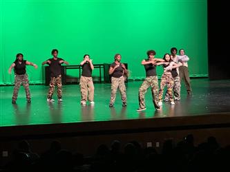 camo dancers on green