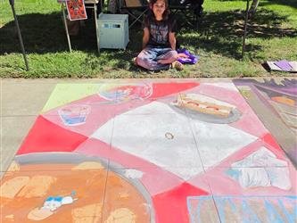 Gianna sitting at top of chalk design