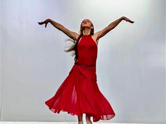 student red dress in dance pose