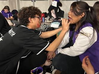 applying make up at Festival of the Arts